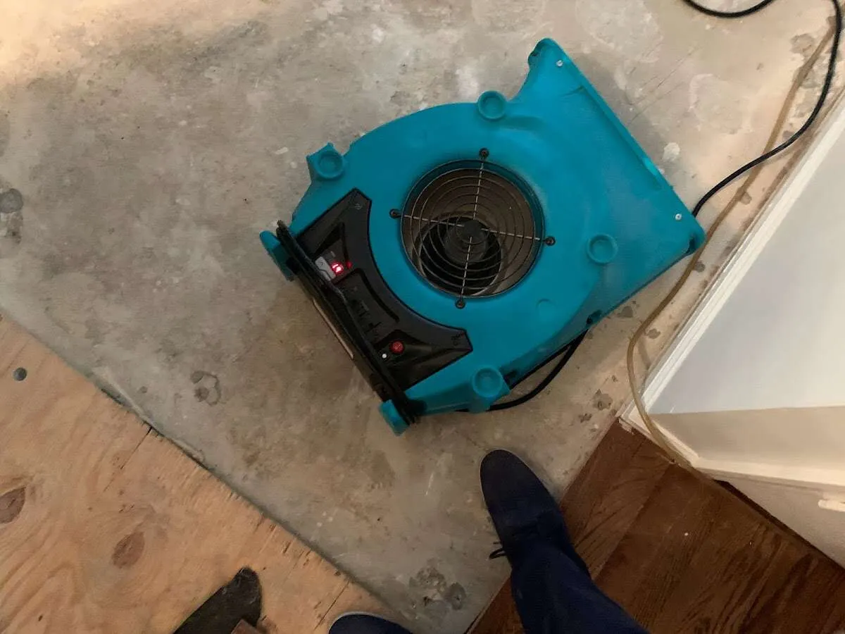Air mover drying subfloor during Leak Detection & Repair in Woodstock